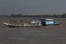 People travel along the Mekong River by boat, in Phnom Penh, Cambodia. Photo: EPA