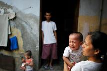 (File) An ethnic Chin refugee child from Myanmar cries as several refugees gather in an alley by their living quarters in New Delhi. Photo: AFP