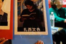 (FILES) This file photo taken on June 4, 2017 shows a volunteer holding a placard of detained Tibetan education advocate Tashi Wangchuk during an event in Taipei marking the 28th anniversary of the 1989 Tiananmen crackdown in Beijing. Photo: AFP