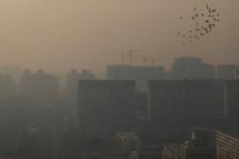(File) A view of buildings shrouded in smog in the capital city of Beijing, China. Photo: EPA