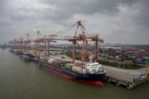 An aerial photo shows cargo ships loading containers in the port on the Beijing-Hangzhou Canal, where the Grand Canal and the Yangtze River meet, near Yangzhou, Jiangsu Province, China. Photo: EPA