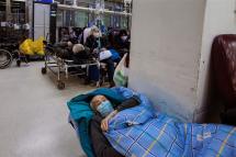 A man lays on a stretcher in an emergency room of a hospital in Shanghai, China, 15 January 2023. Photo: EPA