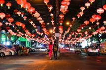 People walk under decorative lanterns ahead of the Chinese New Year in Yangon's Chinatown district on January 31, 2019. Photo: Ye Aung Thu/AFP