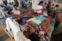Patients lying on beds at a busy ward of a clinic in Yangon. Photo: AFP