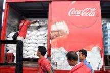 Relief and Rebuild Visit: Coca-Cola delivery trucks arrive in Yae Kyi Township, Ayeryarwady Division, with bottled water, rice and other essential items (Coca-Cola)
