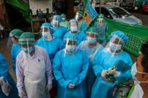 Medical staff, nurses and volunteers wear protective gear amid concerns over the spread of the COVID-19 coronavirus as they prepare for going door-to-door for health check-ups in Yangon on May 17, 2020. Photo: Sai Aung Main/AFP