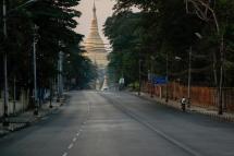 A cyclist on the empty Shwedagon Pagoda road in Yangon, Myanmar, 11 April 2020. Photo: Lynn Bo Bo/EPA