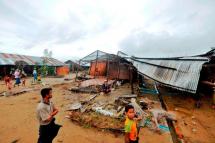 Residents survey the damage caused by cyclone Komen that swept across western Myanmar. Photo: WFP
