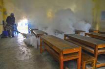 A man fumigates a classroom. Photo: MNA