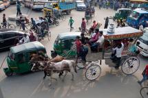 Bangladeshi people commute in a horse carriage in Dhaka, Bangladesh. Photo: Monirul Alam/EPA
