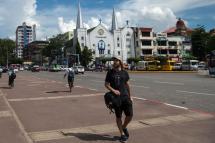 A tourist walking in the downtown area of Yangon. Photo: Ye Aung Thu/AFP
