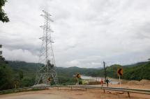 An electricity pylon stands on the hill near Thanlwin (Salween/ Namhkong) river in Shan State. Photo: Lynn Bo Bo/EPA