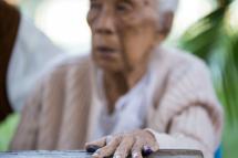 (File) An elderly voter is seen with her ink-stained finger outside a polling centre in Mandalay on November 8, 2015. Photo: AFP