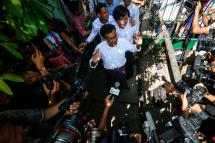Journalists from Eleven media, editor in chief Kyaw Zaw Linn (C), managing editor Nari Min (C-R), and chief reporter Phyo Wai Win (C, back) talk to media in front of Tamwe township court after they were released on bail, Yangon, Myanmar, 26 October 2018. Photo: Lynn Bo Bo/EPA