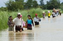 Residents wade through a flooded road in Taungnu township of Bago region on August 31, 2018. Photo: Ye Aung Thu/AFP