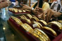 Myanmar vendors arranging a display of gold jewellery at a jewellery shop at Chinatown in downtown Yangon. Photo: AFP