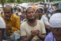 Rohingya refugees pray as they take part in a protest held to mark the five year anniversary of the mass migration of Rohingya refugees from Myanmar to Bangladesh, at a makeshift camp in Kutubpalang, Ukhiya, Cox Bazar district, Bangladesh, 25 August 2022. Photo: EPA