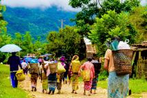 (File) This picture taken on June 12, 2021 shows women walking after receiving food donations in the Mong Paw area in Shan state, as fighting has intensified in the region between the military and various ethnic armed groups in eastern Myanmar since the February military coup. Photo: MNWM / AFP