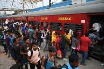 Passengers queue along a platform to board the Chennai bound Coromandel Express at Shalimar station near Kolkata on June 7, 2023. Photo: AFP