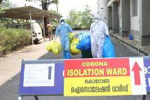 Indian medical staff wearing full protective suits hold medical waste as they exit from the coronavirus isolated ward of the Ernakulam Government Medical College in Kochi, Kerala, India, 03 February 2020. Photo: EPA