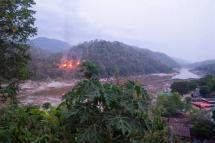 This handout from Kawthoolei Today taken and released on April 27, 2021 shows fires burning at a Myanmar military base along the bank of the Salween river, as seen from Mae Sam Laep town in Thailand's Mae Hong Son province, after the base was attacked and captured by the Karen National Union (KNU) as the country remains in turmoil after the February 1 military coup. Photo: AFP
