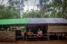(File) Men sitting in a temporary shelter at a camp for internally displaced people (IDPs) in Demoso township in Myanmar's Kayah state. Photo: AFP
