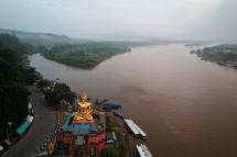 This photo taken on September 20, 2019 shows a giant Buddha on the Thai side of the Golden Triangle in Chiang Rai province, with Myanmar in the background and Laos on the right. Ninety-seven kilometres of rocks in Thai waters stand between Beijing and dominance over the Mekong, a mighty river that feeds millions as it threads south from the Tibetan plateau through five countries before emptying into the South China Sea. Photo: Lillian SUWANRUMPHA / AFP