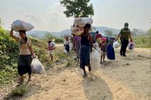 This handout photo taken and released on April 11, 2023 by the Royal Thai Army shows displaced people from Myanmar carrying belongings as they make their way to the Moei river on the Thai-Myanmar border to return from Thailand's Mae Sot district in Tak province. Photo: AFP