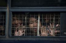Kay Khaing Tun, a performer of Peacock Generation group looks from a prison van window after a trial in Yangon on November 18, 2019. Photo: Sai Aung Main/AFP