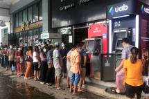 People wait near ATM machines to withdraw the cash in Yangon, Myanmar, 29 April 2021. Photo: EPA