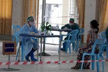 (File) A doctor talks with a patient, while adhering to social distancing measures inside the Community Fever Clinic which opens, temporarily, at Hlaing Thar Yar town hall in Yangon, Myanmar, 29 April 2020. Photo: EPA