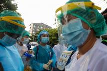 (File) Medical staff, nurses and volunteers wear protective gear amid concerns over the spread of the COVID-19 coronavirus as they prepare for going door-to-door for health check-ups in Yangon on May 17, 2020. Photo: AFP