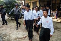 Myanmar students are escorted by police after a court hearing in Mandalay on February 13, 2019. Photo: AFP