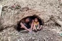 This screengrab from a UGC video provided to AFPTV from an anonymous source taken on April 4, 2021 shows young displaced children sheltering in holes dug in the forest in Myanmar's Pupun district near the border with Thailand, after the civilians fleeing air strikes in their home villages were allegedly pushed back by Thai soldiers to the Myanmar side. Photo: AFP