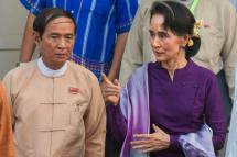 (File) Myanmar democracy icon Aung San Suu Kyi (R) accompanied by Lower House speaker Win Myint (L) leave after meeting National League for Democracy (NLD) members of parliament in Naypyidaw following a parliament session on March 14, 2016 ahead of the presidential election.
