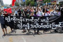 Demonstrators holding poster reading 'Yangon Strike, we will clear all the enemies' during an anti-military coup protest in Yangon, Myanmar, 26 April 2021. Photo: EPA