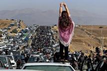 This UGC image posted on Twitter reportedly on October 26, 2022 shows an unveiled woman standing on top of a vehicle as thousands make their way towards Aichi cemetery in Saqez, Mahsa Amini's home town in the western Iranian province of Kurdistan, to mark 40 days since her death, defying heightened security measures as part of a bloody crackdown on women-led protests. Photo: AFP