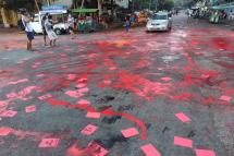 This photo taken and received from an anonymous source via Facebook on April 10, 2021 shows red paint splashed on the ground and flyers promoting a student-led "Red Movement" in protest against the military coup in Yangon. Photo: AFP