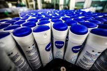 Bottles of Nivea skin care products are processed in a machine in the Beiersdorf AG production facility in Hamburg, Germany. Photo: EPA