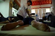 From upscale Bangkok spas to modest street-side shophouses, Thai massage is ubiquitous across the kingdom (AFP Photo/Romeo GACAD) 