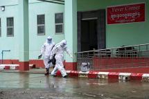  Medical workers wearing personnel wearing PPE (Personal protective equipment) walk past the Fever Corner of a hospital in Sittwe, Rakhine State, western Myanmar, 24 August 2020. Photo: Nyunt Win/EPA