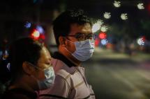 An image made by using a custom bokeh filter, showing Myanmar people wearing protective face masks as a preventive measure against the spread of the COVID-19 novel coronavirus, walking in the the downtown area. Photo: Lynn Bo Bo/EPA