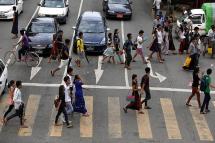 People crossing a busy road in downtown Yangon. Photo: Nyein Chan Naing/EPA
