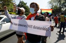 LGBT members hold placards and shout slogan as they march in front of the US Embassy during a protest against the military coup, in Yangon, Myanmar, 10 February 2021. Photo: EPA