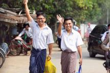 Reuters reporters Wa Lone (L) and Kyaw Soe Oo (R) gesture as they walk to Insein prison gate after being freed, in Yangon, Myanmar, 07 May 2019. Photo: EPA