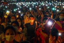 In this file photo taken on March 13, 2021 protesters hold up their mobile phones during a candlelight vigil to honour those who have died during demonstrations against the military coup in Yangon.  Photo: AFP