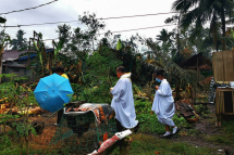 Father Ricardo Virtudazo walks among downed banana trees felled by Super Typhoon Rai. Photo: AFP
