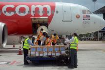 Workers unloading medical supplies from the special flight at the Yangon International Airport on 14 June, 2020. Photo: MNA