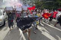(File) Demonstrators holding posters and flares as they march during an anti-military coup protest at downtown area in Yangon, Myanmar, 03 July 2021. Photo: EPA