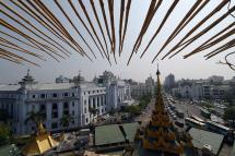 The scaffolding of the Sule Pagoda's tower shows the historic Yangon city hall building (at L) featuring distinct Myanmar architecture fronting Mahabandoola road. Photo: AFP
